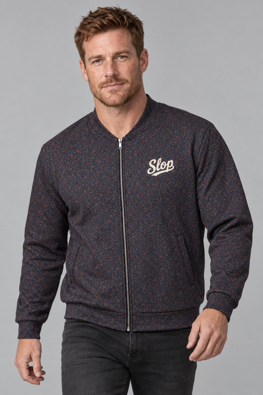 Man wearing the Slop Script Bomber Jacket in Midnight Copper Paisley