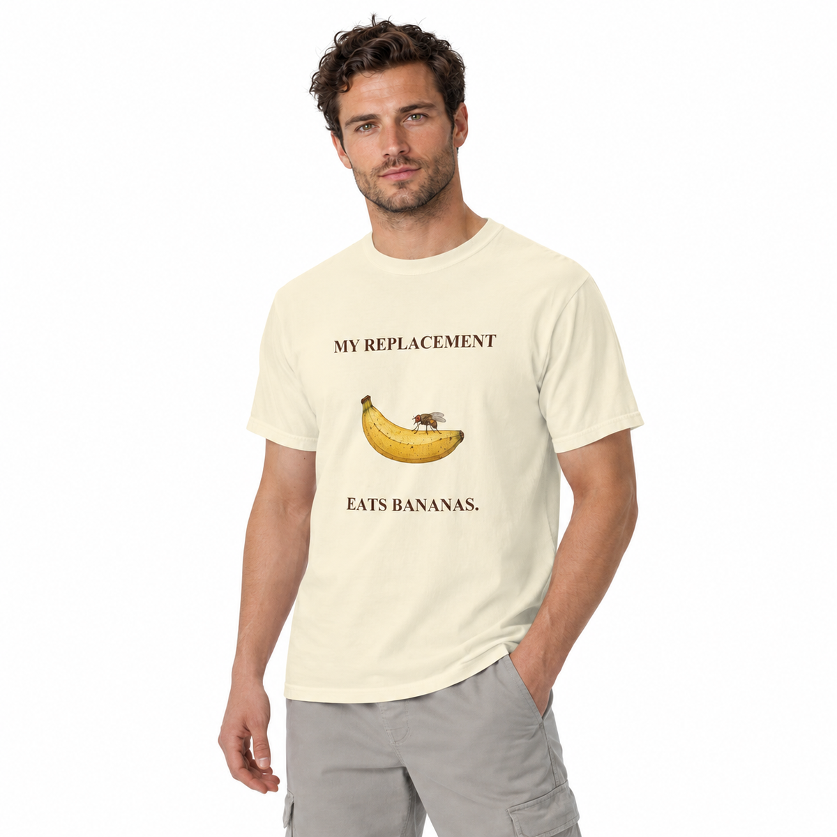 My Replacement Eats Bananas Tee — Ivory — CW-M02 fictional adult model, standing three-quarter; exact provider garment and artwork; digital mockup.