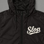 Digital mockup: 098 black garment detail v1; actual EXP54LWZ windbreaker, cream Slop on wearer-left chest only.