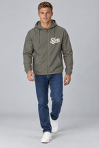 Digital mockup: 098 graphite CW M24 walking v1; actual EXP54LWZ windbreaker, cream Slop on wearer-left chest only.