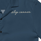 Cannon Coast Beach Button-Up — Navy / Cream — printed chest signature detail cropped from supplier digital mockup; Printful all-over-print unisex button-up shirt Navy and cream all-over print; supplier digital mockup.