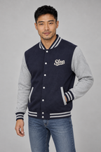 Man wearing the Ivory Script Varsity Jacket in Oxford Navy/Heather Grey