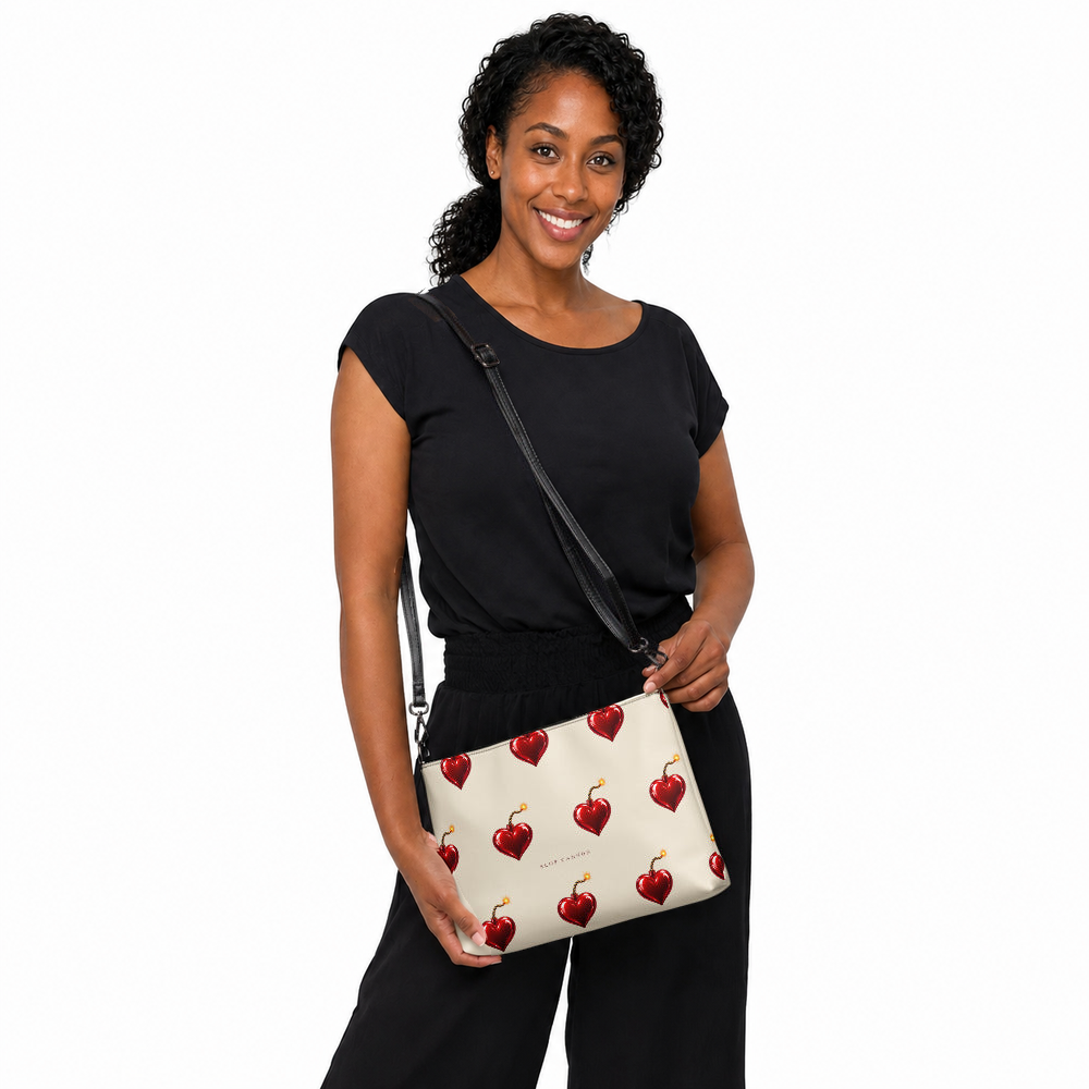 Slop Cannon Heart Fuse Crossbody Bag — Cream / black trim — model-worn front view; bag only; styling clothing excluded; printed faux leather with black trim; digital model composite with exact supplier bag, strap and print pixels. Not a manufactured sample photograph.