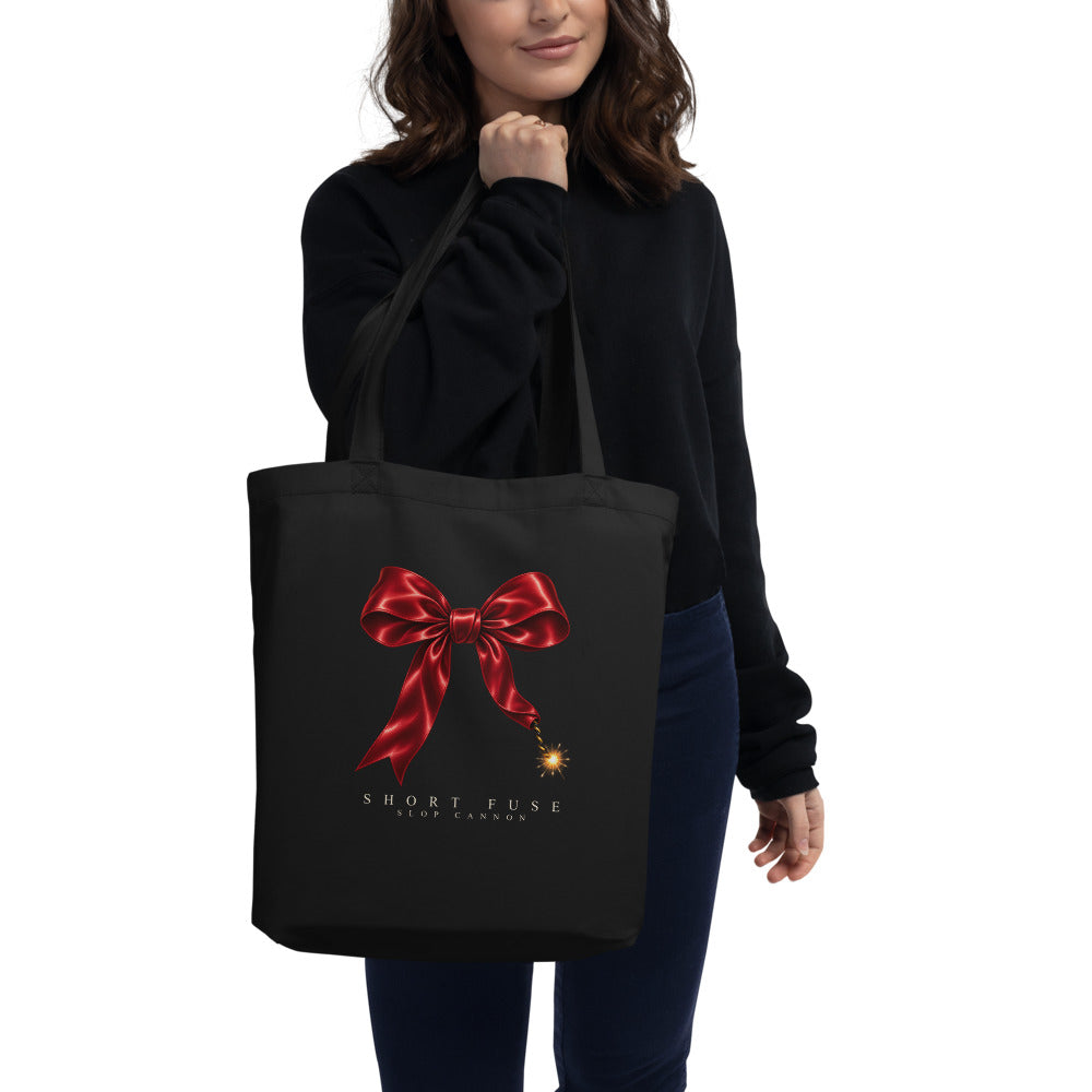 Short Fuse tote — Black — model carrying the tote with approved front artwork; tote only, clothing not included; Econscious EC8000 organic cotton tote; supplier digital mockup.