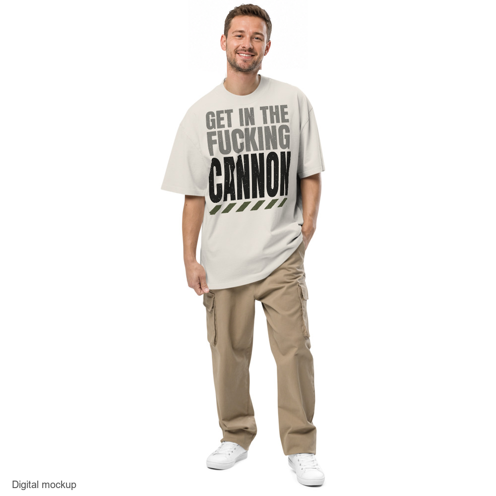 Tall Condensed tee — Cream — adult male model front view, one hand in pocket; exact AS Colour 5082 Faded Bone garment and configured maximum-size artwork; digital mockup, not a manufactured sample; trousers and shoes excluded.