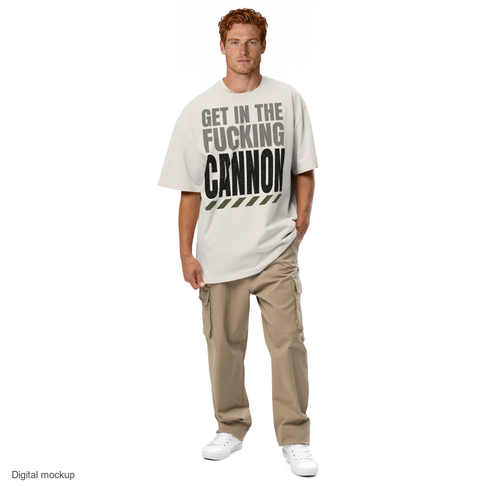Tall Condensed tee — Cream — adult male model front view, one hand in pocket; exact AS Colour 5082 Faded Bone garment and configured maximum-size artwork; digital mockup, not a manufactured sample; trousers and shoes excluded.
