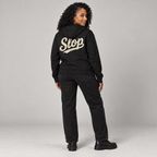 Nia wearing the Black SLOP Work Zip Hoodie in a straight rear view
