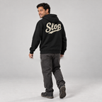 Diego walking in the Black SLOP Work Zip Hoodie, rear view