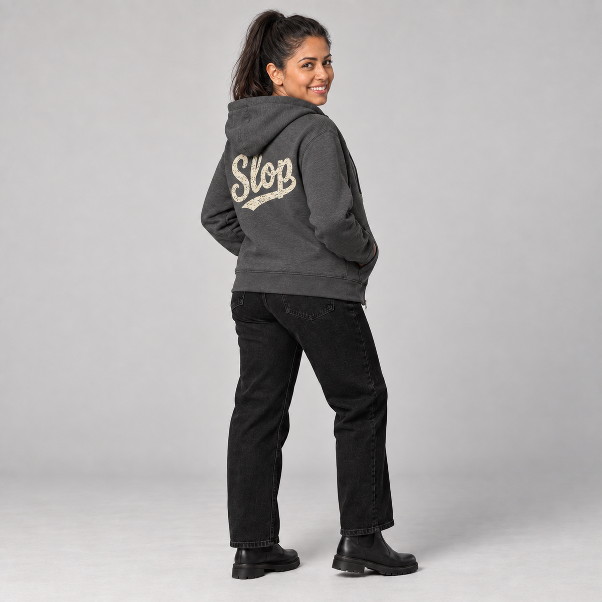 Marisol wearing the Charcoal Heather SLOP Work Zip Hoodie in a rear three-quarter view